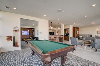 a resident clubhouse with a pool table and bar